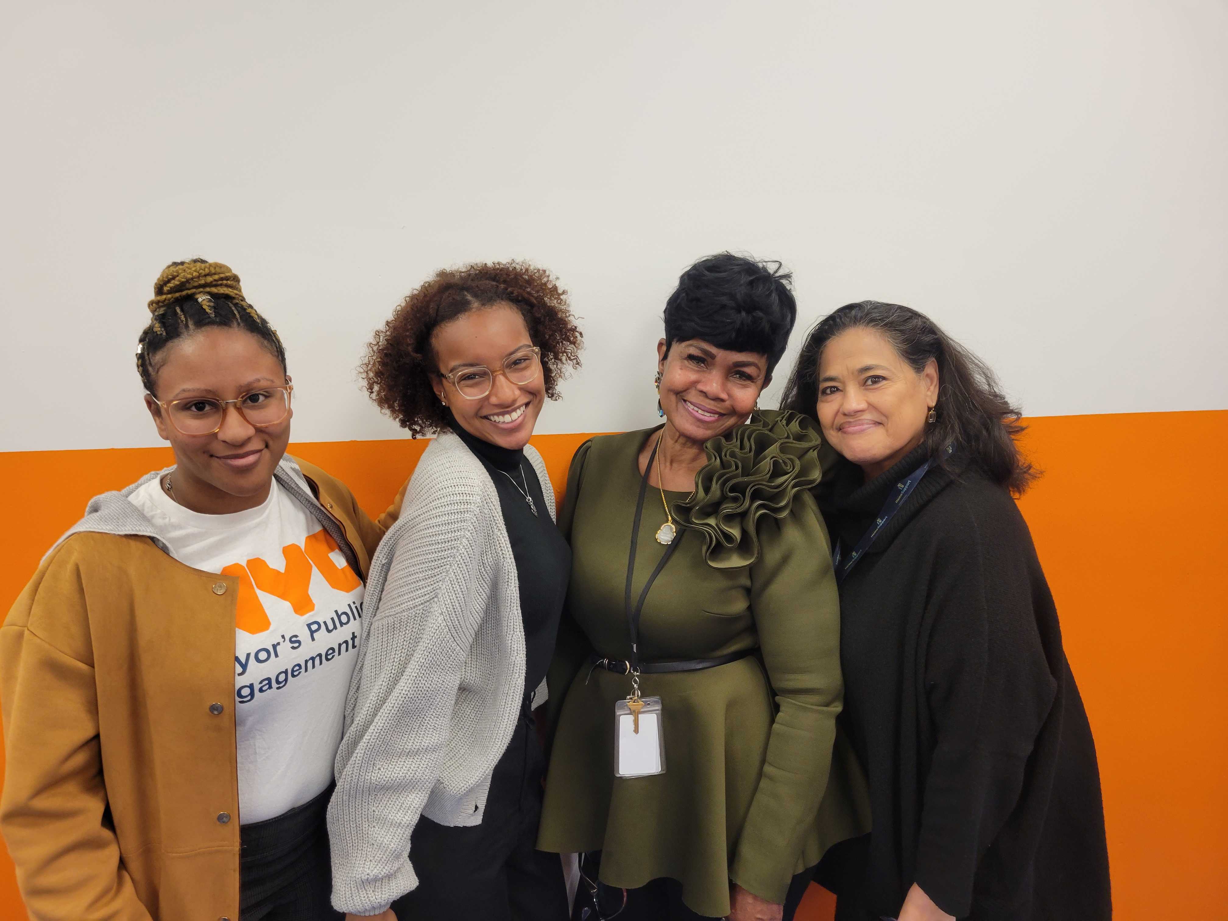 Four people pose for the picture smiling while side hugging. PEU staff stand at the end of each side while Shelter Director and Housing Coordinator stand in the middle 